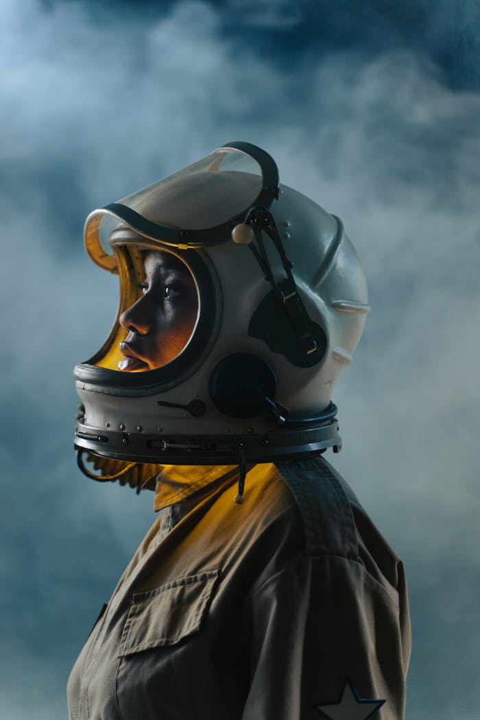 Side view of astronaut wearing a vintage spacesuit with moody lighting.